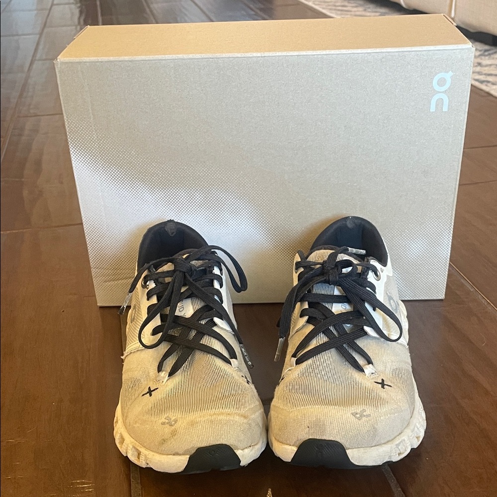 On Running Cream and Black Athletic Shoes
